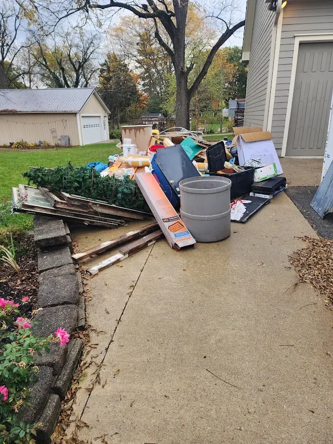Dumpster being loaded with debris for Residential Dumpster Rental in Sugar Land